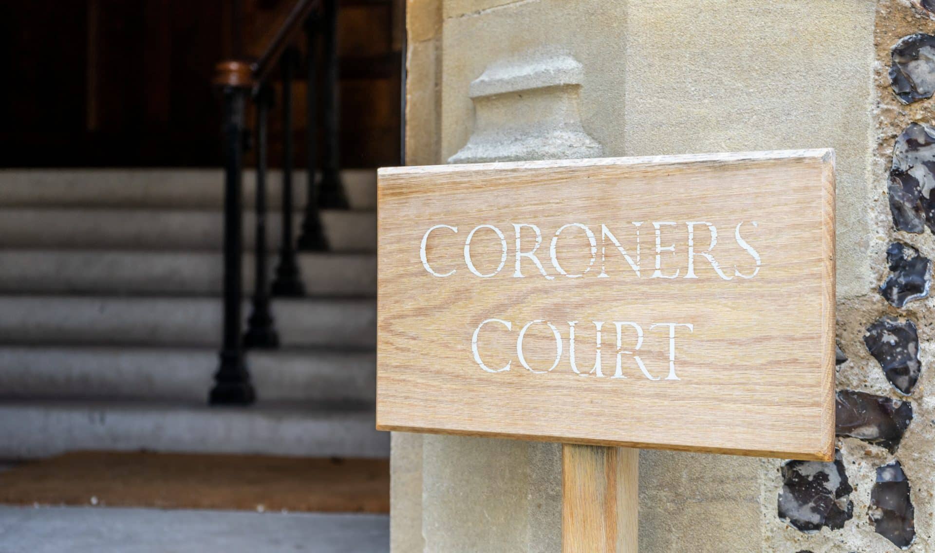 A Wooden Sign Showing The Words Coroners Office
